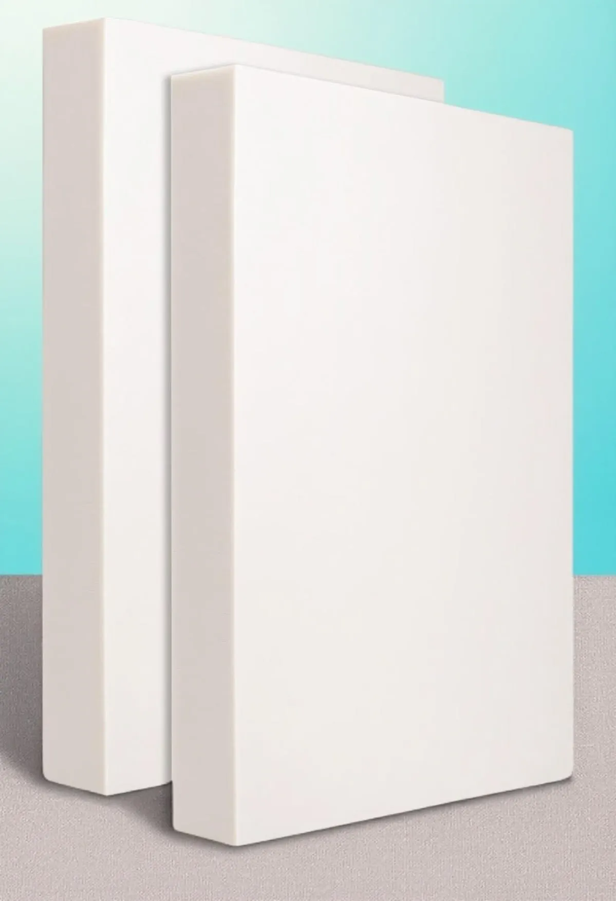 Two white high thickness foam sheets stand vertically against a gray surface and blue background.